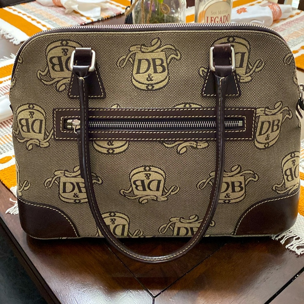 Classic Dooney & Burke purse in signature fabric DB with brown leather trim.
